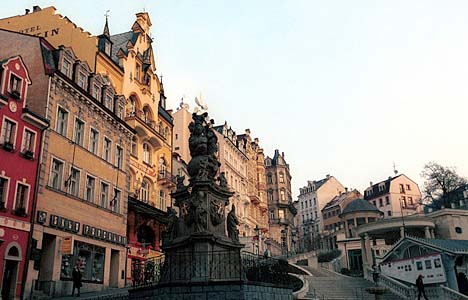 Trinity Column, foreground, on a small square on Stara Louka Street.